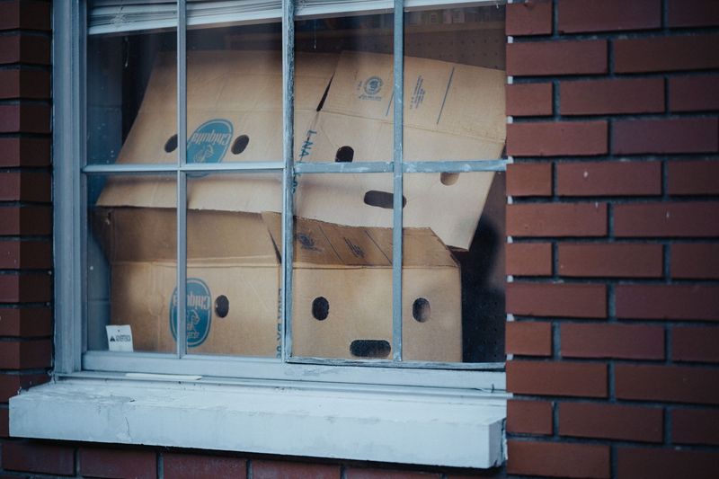 Junk removal professional carefully carrying an old household appliance from a Boise home